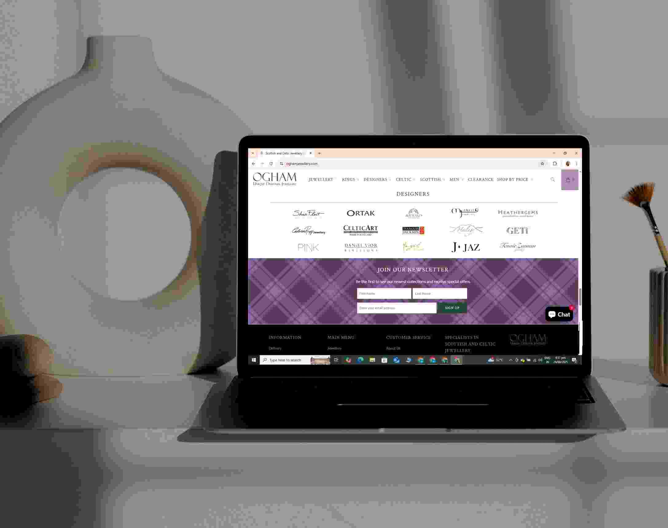 Ogham Jewellery designers directory and newsletter sign-up section shown on a laptop