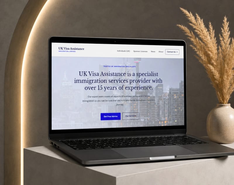 UK Visa Assistance homepage on a laptop: hero for the Glasgow immigration specialists with the three service hubs in the header